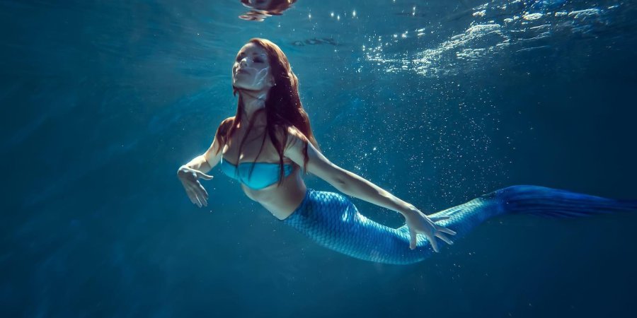 Freediver girl with mermaid tale